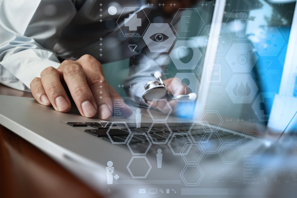 Medicine doctor hand working with modern computer and medical diagram layers on wooden desk as medical concept